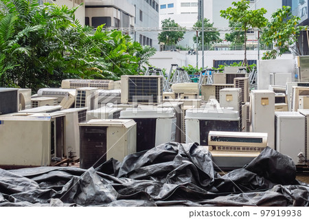 A lot of Air conditioners stacked up in a pile to disposal at recycling garbage dump. Stack of old and dirty air conditioners defective and discarded for recycling process industry. Old appliances. 97919938
