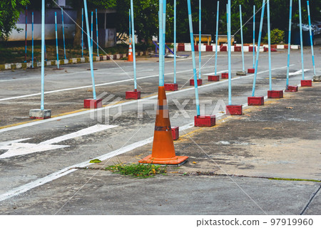 Driving test and training area with simulate test for driving license. Driving school practice traffic area with pole signs and orange cones and road signs for safety on concrete road. Selective Driving test and training area with simulate test for driving license. Driving school practice traffic area with pole signs and orange cones and road signs for safety on concrete road. Selective 97919960
