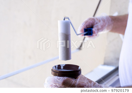 Box of white paint and a painting roller 97920179