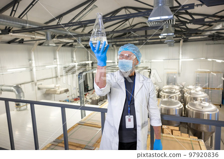 Brewer performing the quality check of a beverage sample Brewer performing the quality check of a beverage sample 97920836