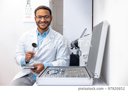 Male doctor in lab coat at his working palce 97920852