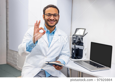 Male doctor in eye glasses looking positive and friendly Male doctor in eye glasses looking positive and friendly 97920864