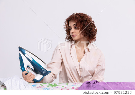 Boring household chores. Pause while ironing men's shirts. Boring household chores. Pause while ironing men's shirts. 97921233