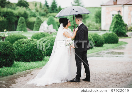Gorgeous happy couple standing close to each other and looking in eyes 97922049