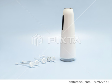 Oral teeth irrigator with nozzle pack, dental water tooth cleaner, white portable rechargeable cordless water dental flosser on blue background. Waterproof home dental care device. Horizontal 97922332