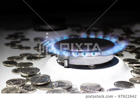 Money and gas burner on a white background with space for text. The cost, price of natural gas in the world Money and gas burner on a white background with space for text. The cost, price of natural gas in the world 97922642