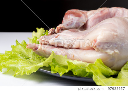 Raw rabbit meat, cooking meat, meat on lettuce Raw rabbit meat, cooking meat, meat on lettuce 97922657