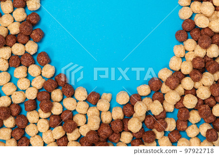 Corn sweet balls on a blue background with place for text. Quick breakfasts, top view Corn sweet balls on a blue background with place for text. Quick breakfasts, top view 97922718