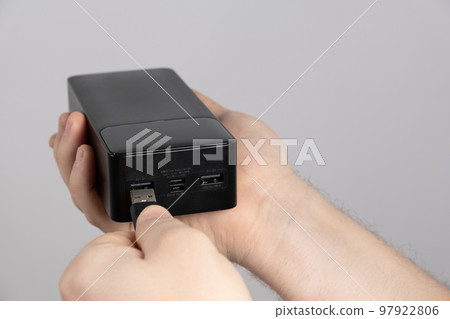 Connecting the cord to the power bank. Charging gadgets from the power bank. 97922806