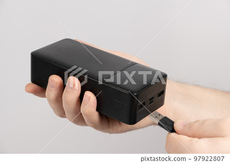 Connecting the cord to the power bank. Charging gadgets from the power bank. 97922807