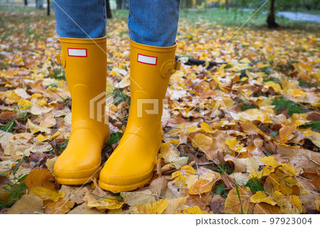 bright autumn. girl in yellow rubber boots walking bright autumn. girl in yellow rubber boots walking 97923004
