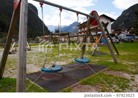 empty playground in a small alpine town 97923025