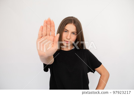 Portrait of confident young woman making stop gesture Portrait of confident young woman making stop gesture 97923217