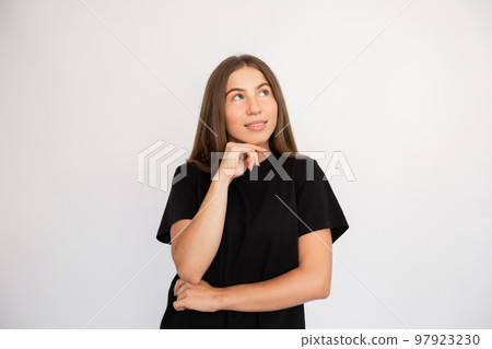 Portrait of thoughtful young woman looking away Portrait of thoughtful young woman looking away 97923230