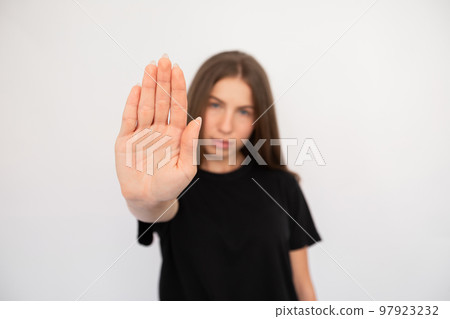 Close-up of female hand making stop gesture on white background Close-up of female hand making stop gesture on white background 97923232