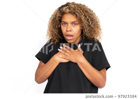 Scared African American woman pressing hands to chest 97923384