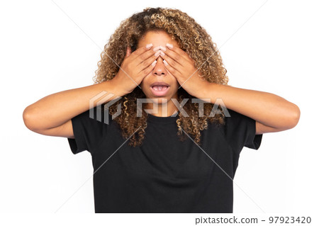 Shocked African American woman covering eyes Shocked African American woman covering eyes 97923420