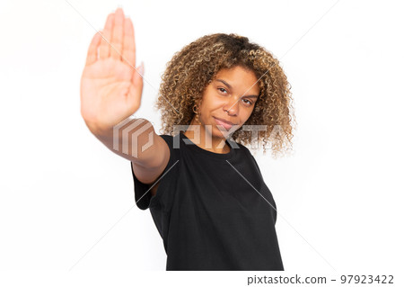 Happy African American woman showing stop sign Happy African American woman showing stop sign 97923422