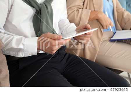 Man with tablet waiting for job interview in office, closeup 97923655