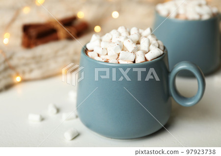 Delicious cocoa drink with marshmallows on white table 97923738