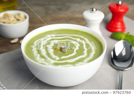 Delicious broccoli cream soup served on table Delicious broccoli cream soup served on table 97923760