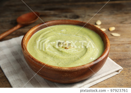Delicious broccoli cream soup served on wooden table Delicious broccoli cream soup served on wooden table 97923761