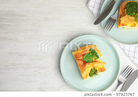 Tasty broccoli casserole served on white wooden table, flat lay. Space for text Tasty broccoli casserole served on white wooden table, flat lay. Space for text 97923767