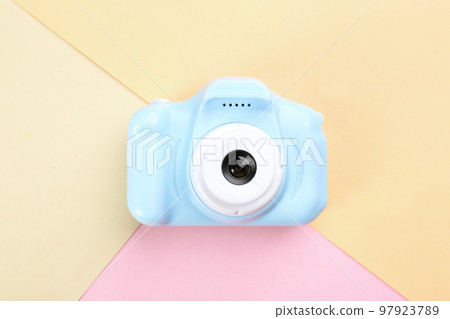 Light blue toy camera on color background, top view Light blue toy camera on color background, top view 97923789