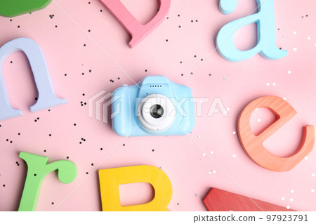 Toy camera and colorful wooden letters on pink background, flat lay. Future photographer Toy camera and colorful wooden letters on pink background, flat lay. Future photographer 97923791