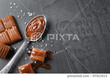 Salted caramel on grey table, flat lay. Space for text 97923815