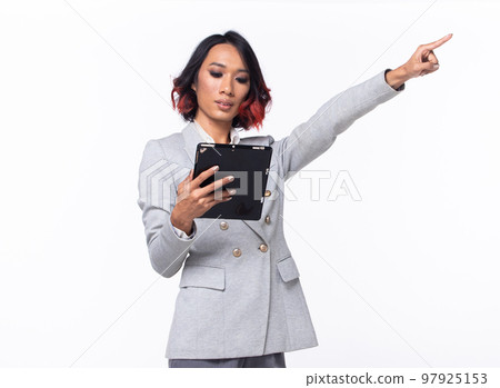 Half body Tanned skin Asian Indian woman points finger hand up to Sky, Business Blazer female has confident smart hold tablet to future empty area air, studio white background isolated 97925153