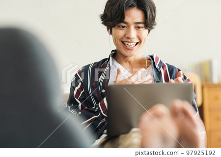 young man talking online young man talking online 97925192