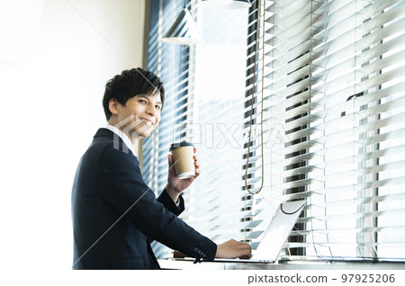 Young businessman working in a cafe Young businessman working in a cafe 97925206