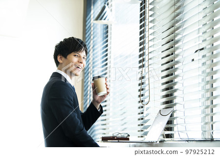 Young businessman working in a cafe Young businessman working in a cafe 97925212