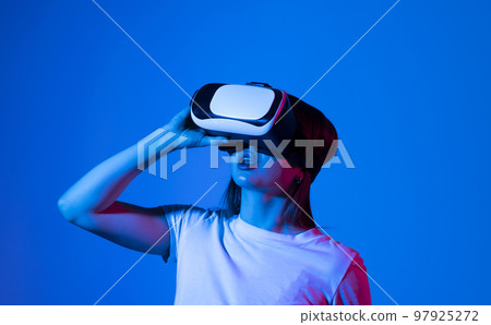 Young woman in virtual reality VR glasses playing a video games. Young woman in virtual reality VR glasses playing a video games. 97925272