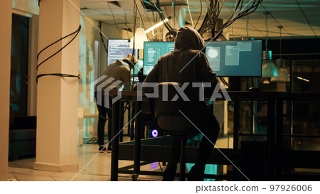 Woman hacker planning phishing and espionage at night, trying to break server firewall for cryptojacking or cyberbullying. Criminal hacking network system on computer, anonymous. 97926006