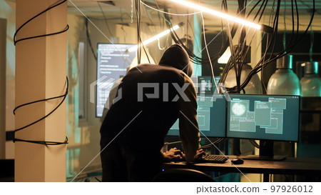 Successful hacker planning data breach to take sensitive information without authorization. Male thief doing espionage and breaking into computer system with dark web malware. Successful hacker planning data breach to take sensitive information without authorization. Male thief doing espionage and breaking into computer system with dark web malware. 97926012