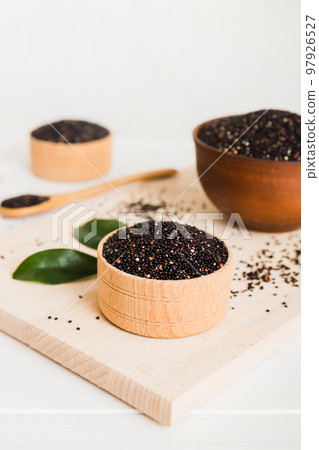 quinoa seeds in bowl and spoon on colored background. Healthy kinwa in small bowl. Healthy superfood quinoa seeds in bowl and spoon on colored background. Healthy kinwa in small bowl. Healthy superfood 97926527
