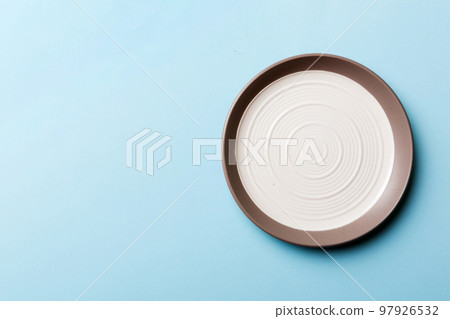 Top view of isolated of colored background empty round white plate for food. Empty dish with space for your design Top view of isolated of colored background empty round white plate for food. Empty dish with space for your design 97926532