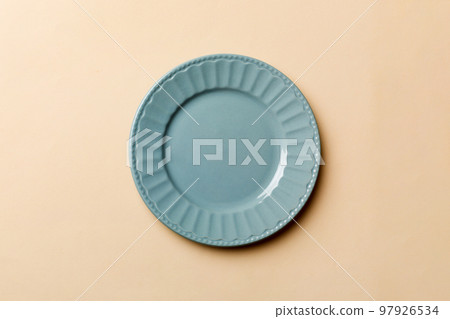 Top view of isolated of colored background empty round blue plate for food. Empty dish with space for your design Top view of isolated of colored background empty round blue plate for food. Empty dish with space for your design 97926534