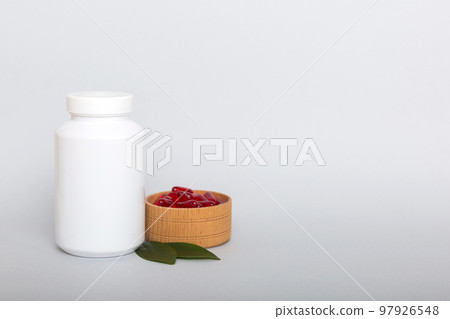 different drugs and health supplement pills with medicine bottle health care and medical top view. Vitamin tablets. Bottle with colored pills on table background. Multivitamins 97926548