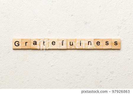 gratefulness word written on wood block. gratefulness text on cement table for your desing, concept 97926863