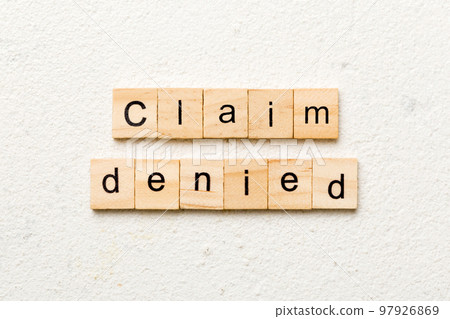claim denied word written on wood block. claim denied text on table, concept claim denied word written on wood block. claim denied text on table, concept 97926869