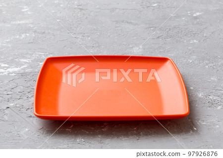 Perspective view of empty square plate on cement background. Empty space for your design 97926876