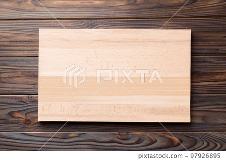 Top view of wooden cutting board on wooden background. Empty space for your design.= Top view of wooden cutting board on wooden background. Empty space for your design.= 97926895