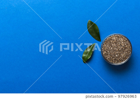 Chia seeds in bowl on colored background. Healthy Salvia hispanica in small bowl. Healthy superfood 97926963