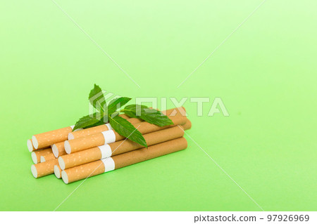 Menthol cigarettes and fresh mint leaves on colored background, Many cigarettes stacked together top view flat lay 97926969