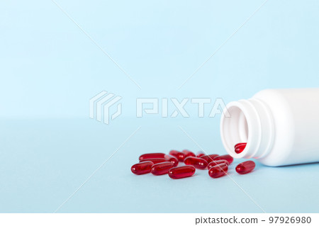 Red pills spilled around a pill bottle. Medicines and prescription pills flat lay background. Red medical capsules Red pills spilled around a pill bottle. Medicines and prescription pills flat lay background. Red medical capsules 97926980