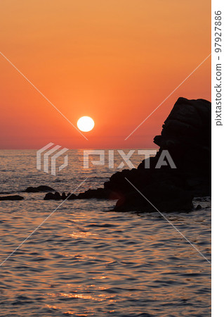 Beautiful view of orange sunset with rocks in Calabria, Mediterranean Sea, Italy. Tropical colorful sunrise landscape 97927886