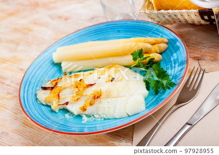 Baked Atlantic halibut fillet with asparagus 97928955